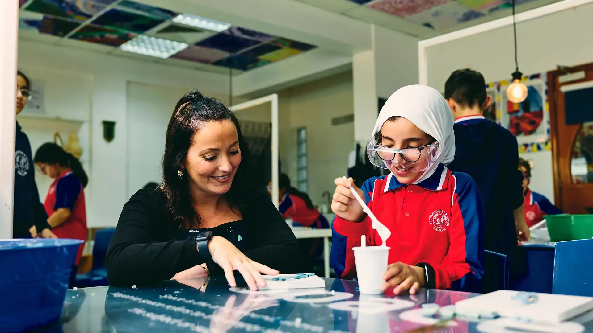 Teacher helping student in class